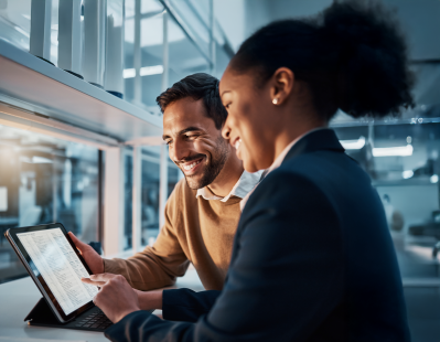 Account manager and quality manager reviewing text-based laboratory test results on a tablet inside a modern lab.
