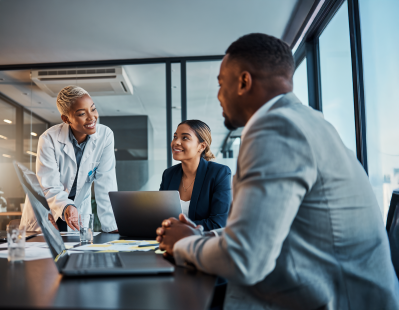 Scientist, account manager, and two quality managers meeting and discussing testing solutions in a modern laboratory office.